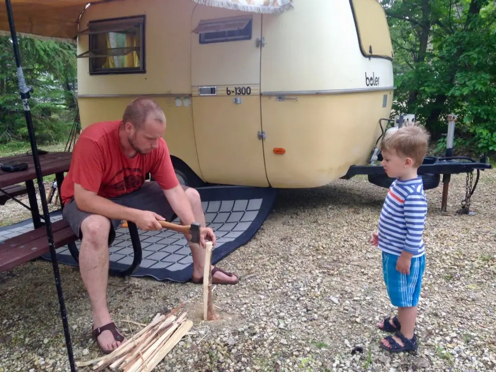 A man and boy in front of an rv.