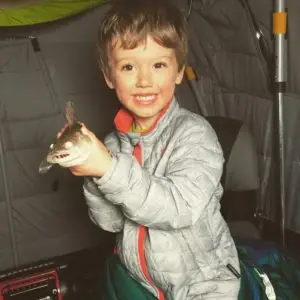 A young boy holding something in his hand.