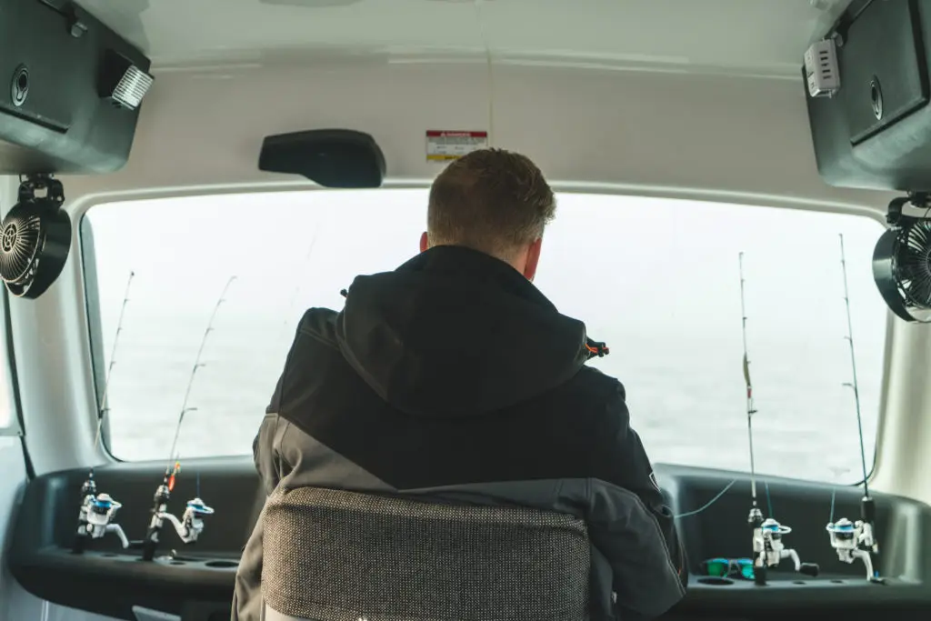 A man sitting in the back of a car.