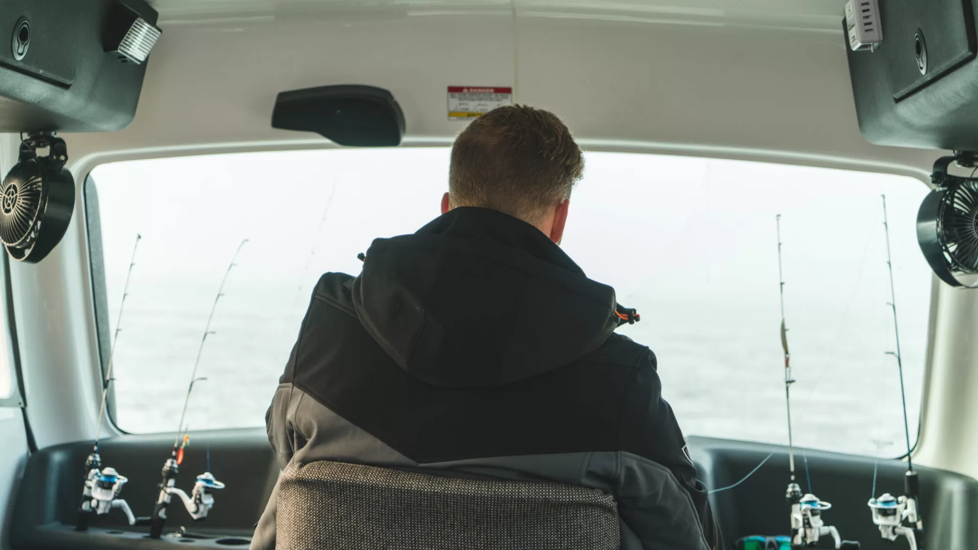 A man sitting in the back of a car.