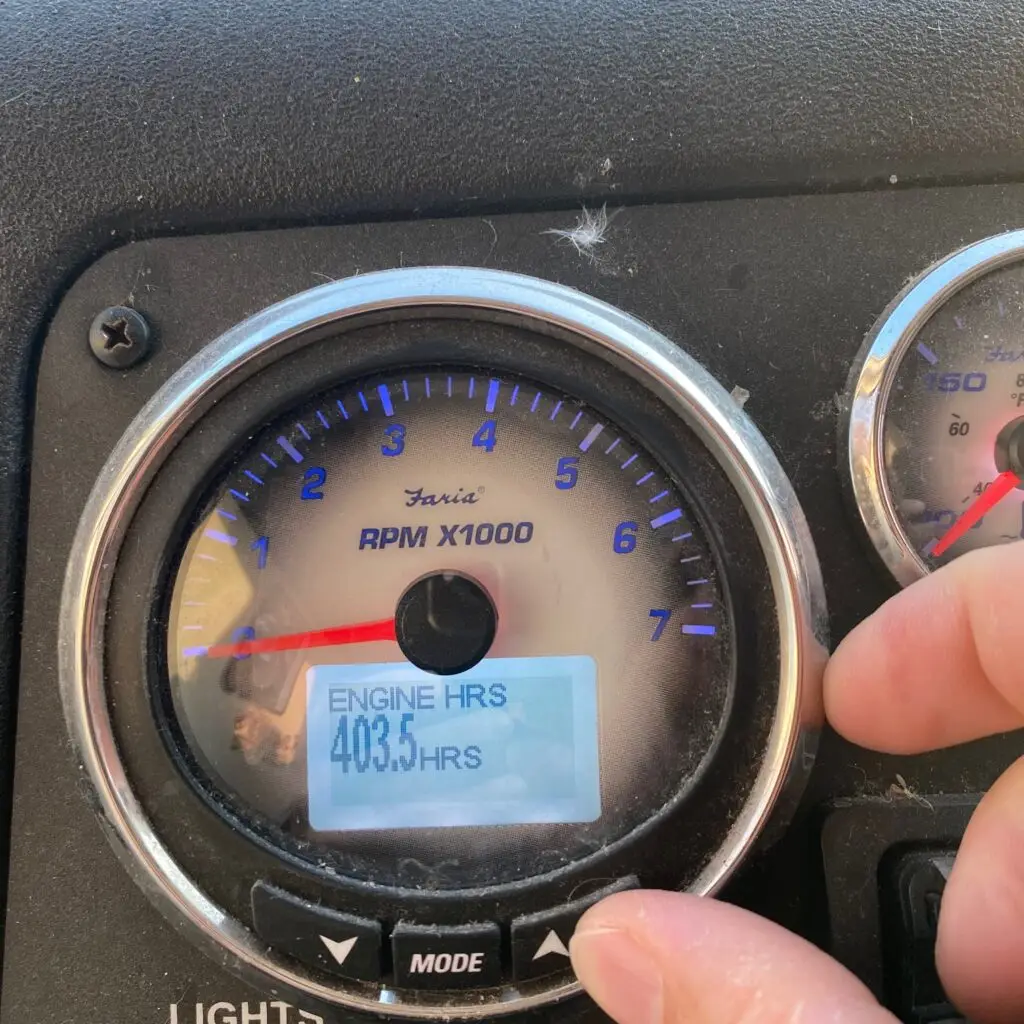 A person is touching the air vent of an instrument cluster.