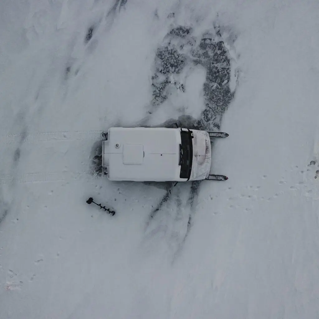 A car is shown in the snow with no one around.