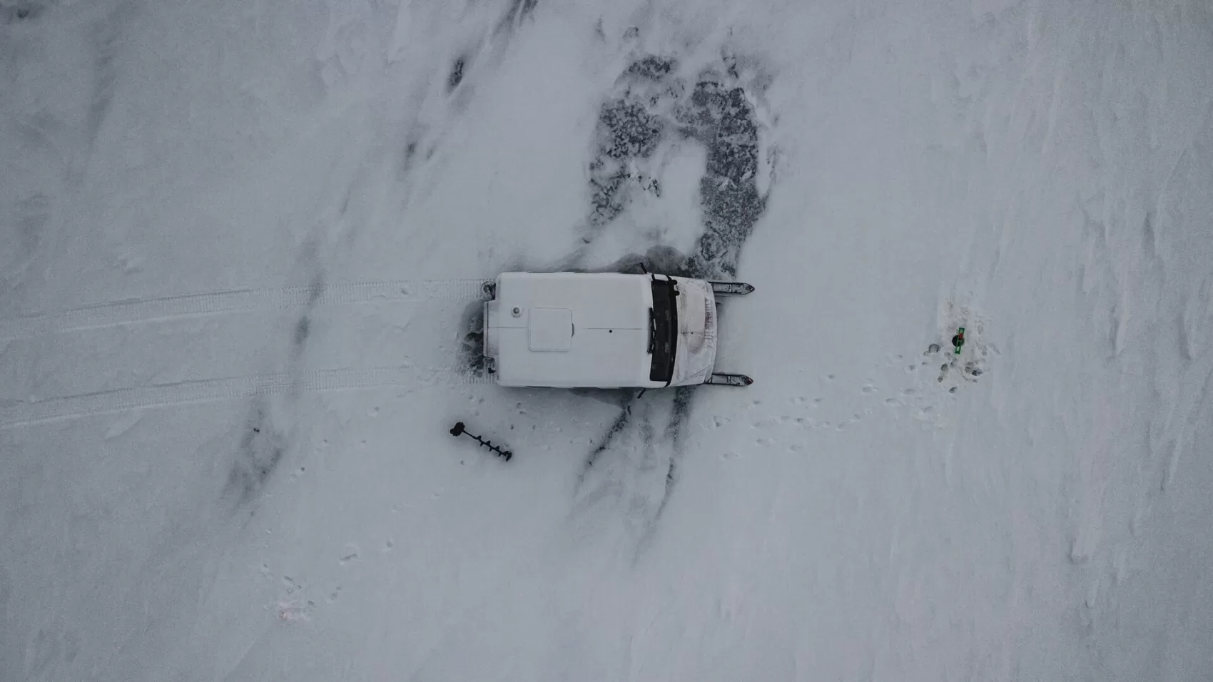 A car is shown in the snow with no one around.