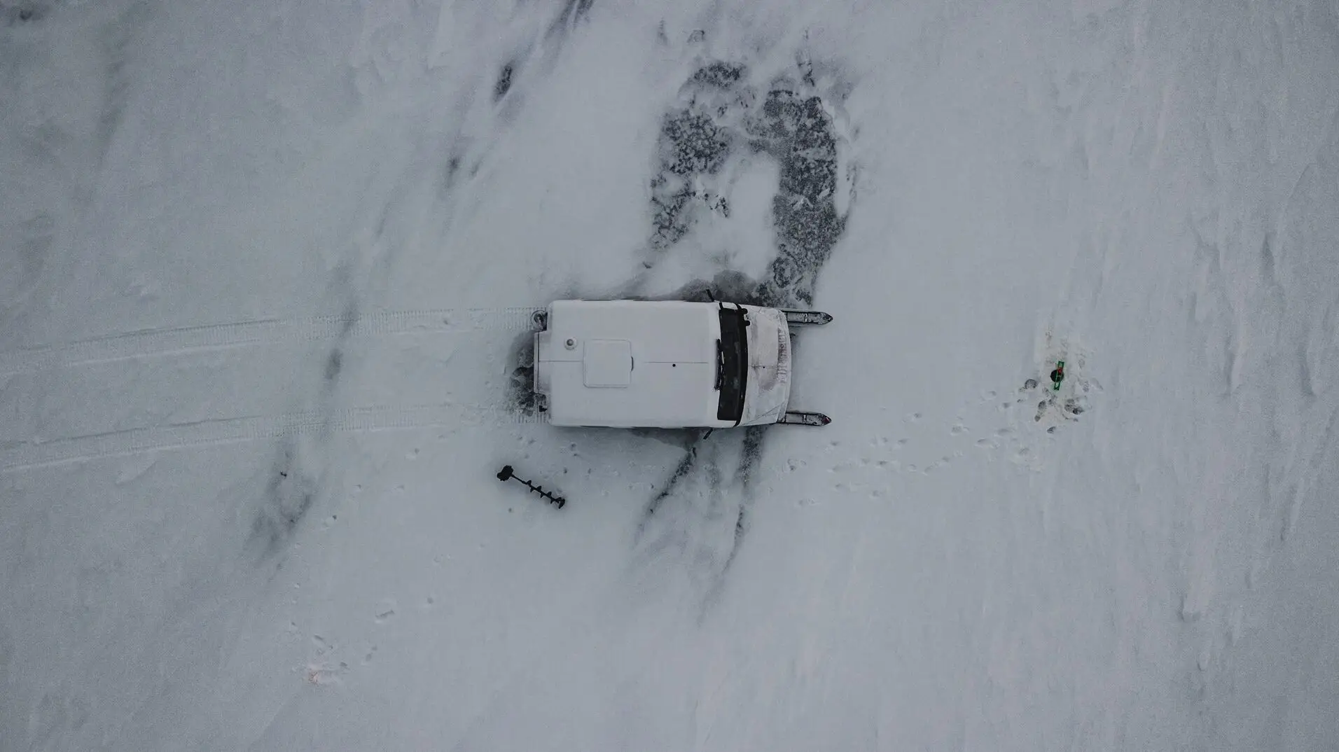 A car is shown in the snow with no one around.