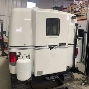 A white truck with a gas tank on the back.